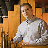 [Joe Vitacco III standing in the Echo Organ at Woolsey Hall ]